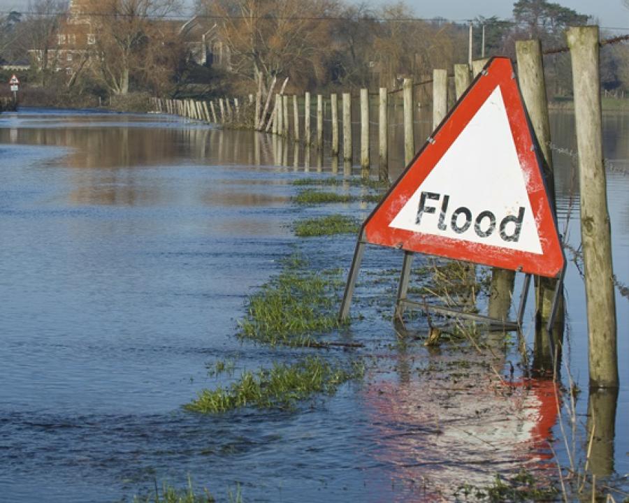 flood sign on a flooded road